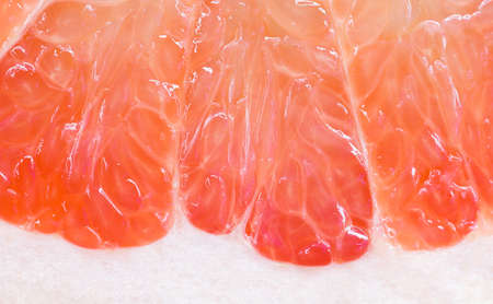 grapefruit texture background. macro of red grapefruit. red grapefruit center texture macro background. Close-up. Delicious and beautiful grapefruit. So fresh!の写真素材