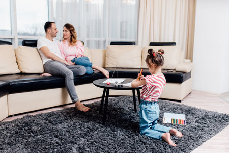 Happy young family staying at home. family enjoying tender moment, smiling parents and preschool children having fun togetherの写真素材