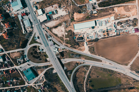 aerial view of an industrial area infrastructure on the outskirts of the city. highway, cars, buildings, sunny spring day. Transportation and Infrastructureの写真素材