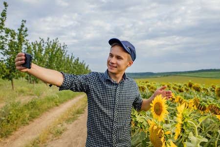 young farmer recording content for the lifestyle blog vlog, modern farmer using social media for marketingの写真素材