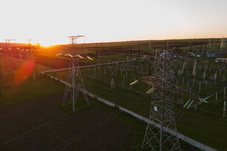 aerial view of High voltage power lines. Electricity distribution station at sunset. Impression...
