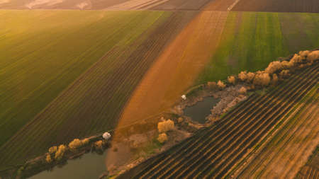 aerial view of Countryside area aerial landscape. Rural life scenery. Amazing landscape of agriculture field aerial view. drones flight over agricultural land in the evening at sunset.の写真素材