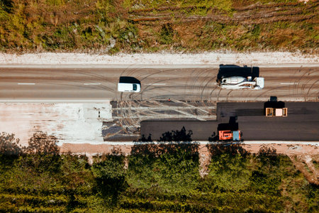 aerial view top view, group of special vehicles deals with road construction. road repair. Work on...