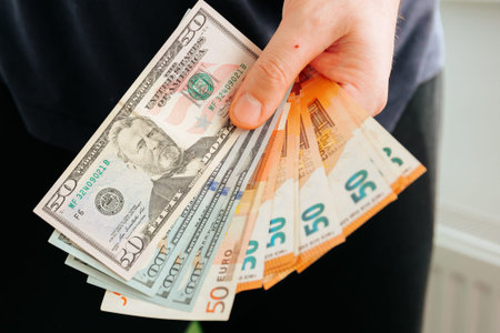 hands showing euro and dollars banknotes. Finance and business concept. Counting holding and showing...