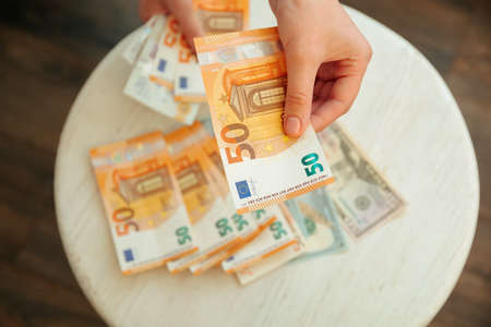 hands counting, pound and dollars banknotes. Finance and business concept. 4K footage. Counting holding and showing money or giving money concept.の写真素材