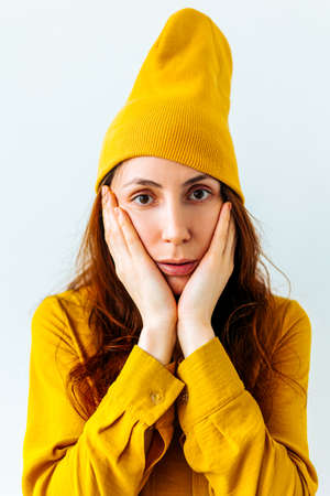 scared young woman looking at camera. Negative facial emotions on the worried female hipster faceの写真素材