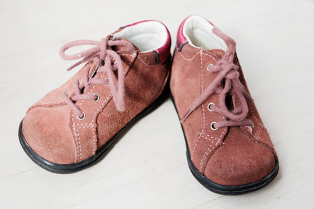 Close up, childrens crimson shoes, baby little girl shoes. for newborn girl, shoes for children.