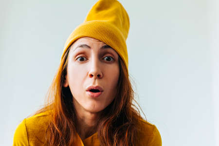 scared young woman looking at camera. Negative facial emotions on the worried female hipster faceの写真素材