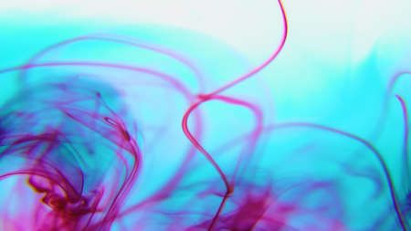 Mix multicolor paint ink drops in water background with copy space. drop of Ink color mix paint falling on water Colorful ink in waterの写真素材