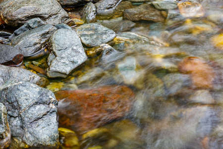 long exposure of a River stream on mountain valley. Slow motion surface boiling water in the mountain river. Fresh water bubbling from source. croppedの写真素材