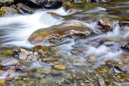 long exposure of a River stream on mountain valley. Slow motion surface boiling water in the...