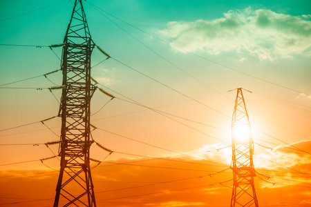 Tower and High Voltage Power Line at sunset. Power line with cloudy yellow sky on background 4k power, line, High, voltage, TimeLapse, Colorful, tower, electricity, pylons, cloudy, sky, energetic,の写真素材