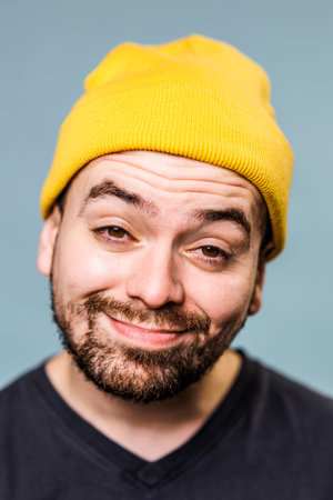 The man in this portrait is captured in a moment of pure hilarity, his grimace facial expression and...