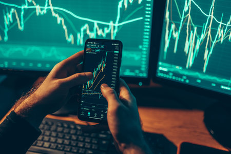 A close-up shot of his hands holding a smartphone and calculator, combined with the glowing computer...