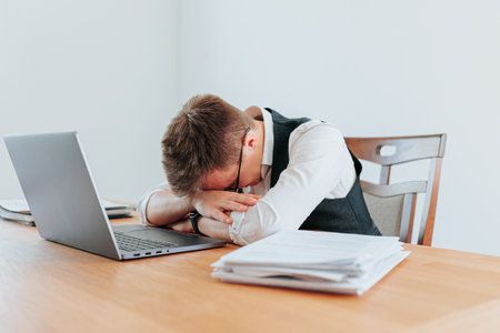 A tired office worker takes a nap at his desk, exhausted from a long day of problem-solving and stress. Office Dreams The Secret Lives of Tired Workersの写真素材