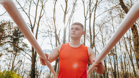Young Athletic Guy in Red T-shirt A Portrait of Style and Health Outdoors, Handsome Model in Authentic Red Sportswear A Young Adults Portrait of Fashion and Fitnessの写真素材