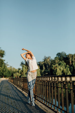 Active Teen Exercise and Sporting Outdoors. Fitness Healthy Lifestyle Young Woman make a break after running in the forest. Caucasian brunette female exercising outdoor, Sport lifestyle.の写真素材