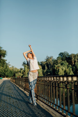 Teen Fitness Outdoors Stretching and Strengthening. Fitness Healthy Lifestyle Young Woman make a break after running in the forest. Caucasian brunette female exercising outdoor, Sport lifestyle.の写真素材