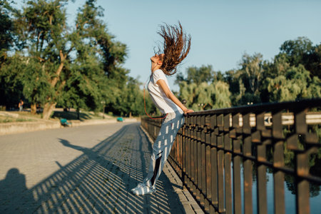 Fitness Healthy Lifestyle Young Woman make a break after running in the forest. Caucasian brunette female exercising outdoor, Sport lifestyle.の写真素材
