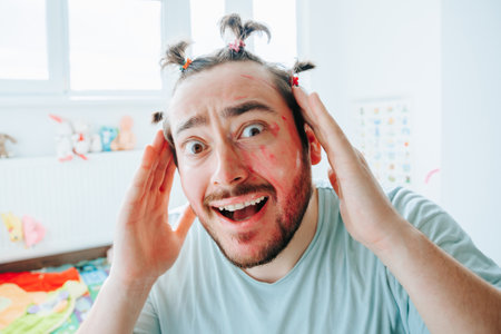 A bearded man with makeup is amused by something funny. The Overwhelmed Funny Man with Make Upの写真素材