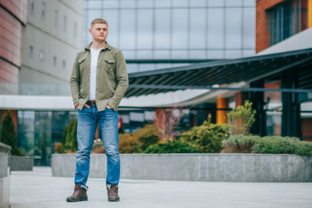 This cool and modern portrait captures the elegance and charm of a young man with blond hair. Elegant European Male Outdoor Portrait in Modern Styleの写真素材