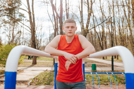 Young Sportsman in Authentic Red Sportswear A Portrait of a Fashionable and Active Outdoorsman. Portrait of a Youthful and Fashionable Guy in Red T-Shirt A Model of Authenticityの写真素材