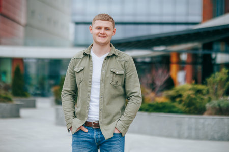 portrait, a handsome and stylish young man is captured looking at the camera with a delighted smile, exuding positivity and optimism. His blond hair and good looks perfectly complementの写真素材