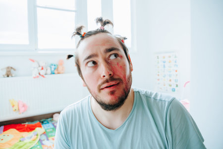 A bearded man making a grimace while having fun at home with friends, causing everyone to burst out laughing with joy. The Comedic Genius Bearded Man Making a Grimaceの写真素材
