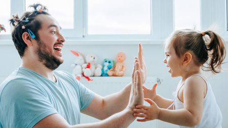 This photo captures the beautiful relationship between a father and his child. Happiness at Home A Fun-Filled Family Time with Father and Kidsの写真素材