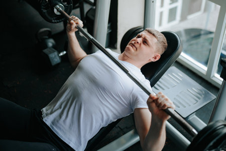 dynamic crossfit training session at a specialized gym, utilizing barbells for various physical exercises. Building Strength Physical Exercises with Barbell in the Gymの写真素材