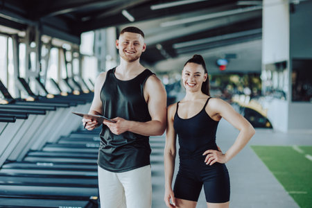 Fit couple alert A young man and woman posing for a gym portrait. Fitness Dedication Young Man and...