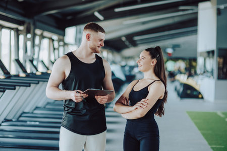 Confident gym-goers Portrait of a young man and woman in sportswear, camera-ready. Powerful Presence Gym Portrait of a Young Man and Womanの写真素材