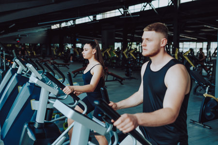 Caucasian male and Hispanic female athletes engaging in a competitive sports activity. Caucasian Man and Hispanic Woman Demonstrating Athletic Prowessの写真素材