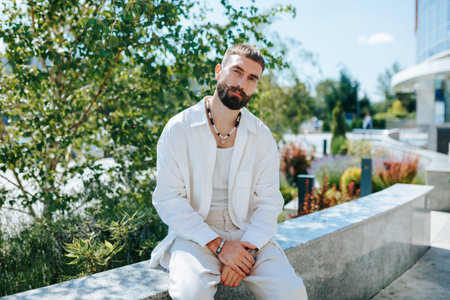 Incredible Confidence Portrait of a Handsome Caucasian Young Man, the Epitome of Cool, Posing Outdoors and Gazing into the Camera.の写真素材