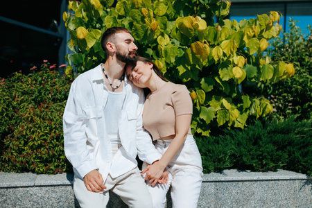 Happy young couple, hand in hand, cherishing their time together outdoors. Portrait of a Happy Caucasian Couple Holding Hands Outdoorsの写真素材
