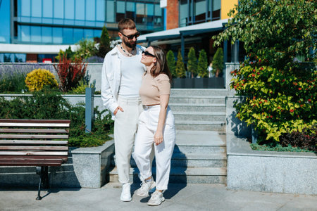 A couple, young and in love, sharing a tender moment outside. Joyful Young Couple Holding Hands Outsideの写真素材