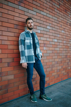 Fashion-forward and confident, this city street portrait highlights a fashionable bearded male. Fashionable Bearded Male looking at camera City Street Portraitの写真素材