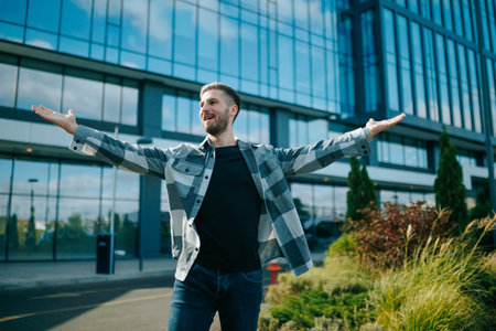 In the heart of the city, a joyful American stands tall, celebrating his achievement. The authentic happiness he radiates is captured beautifully.の写真素材
