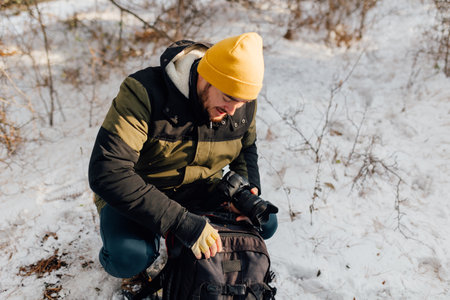 Snowscape Explorer Amidst falling snowflakes, a photographer treks through winters embrace, converting the serene snowy landscapes into a photographic playground of exploration and creativity.の写真素材