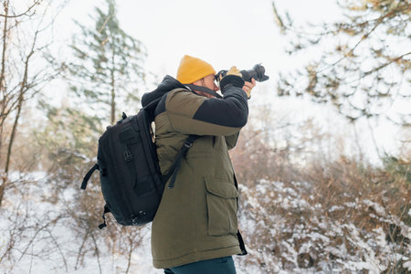 Frozen Frames Expedition A young photographers wintertime journey unfolds, capturing the essence of snow-laden landscapes during an adventurous trek.の写真素材