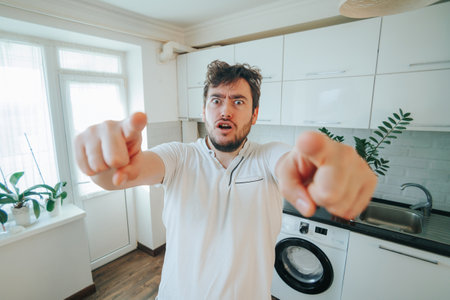lose-up of a bearded man staring with wild eyes, exuding a crazy and annoying vibe, pointing directly at the cameraの写真素材