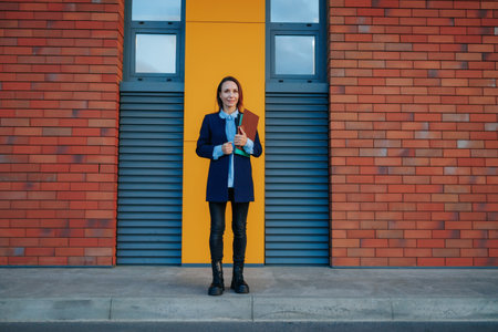 Corporate Confidence A White Collar Worker Showcasing Business Success in a Stylish Outdoor Portrait. A Cinematic Exploration of the Modern Woman Triumph in the Corporate Worldの写真素材