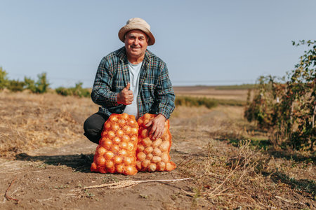 Rural Portrait A Mature Man Stands Proudly with His Vegetable , a Testament to His Passion for Agriculture. Dedication to Agriculture Aged Farmer with thumb upの写真素材