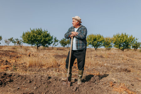 Countryside Wisdom Aged Hispanic Farmer with a Hat, Standing Proud in the Field. Rural Wisdom Portrait of a Senior Farmer in the Countrysideの写真素材
