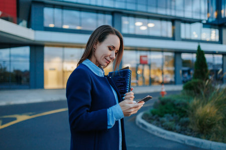 Urban Elation Smiling Businesswoman Spreads Positivity with Professional Triumphs. Urban Triumph Smiles of a Successful Business person in the City.の写真素材