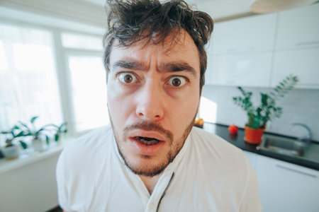 In this intriguing close up, tousled locks frame a face expressing sheer amazement, creating a captivating visual narrative that speaks volumes.の写真素材