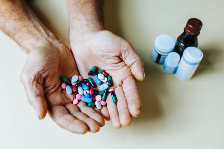 Unrecognizable vitamins and minerals form of tablets are poured from hand to hand of person studio isolated. White background, many tablets, prescribed treatment. Concept medicine, concept of health.の写真素材
