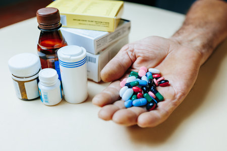 close up Person holds pills in his hands. Multicolored medicines, many tablets, large dose of medicines. Doctor prescribed long term treatment.の写真素材