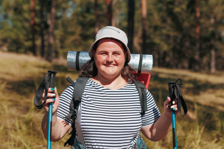 of freedom in a soul stirring video featuring an overweight woman looking at camera on a liberating hiking retreat, celebrating the beauty of nature and the empowerment found in each stride.の写真素材