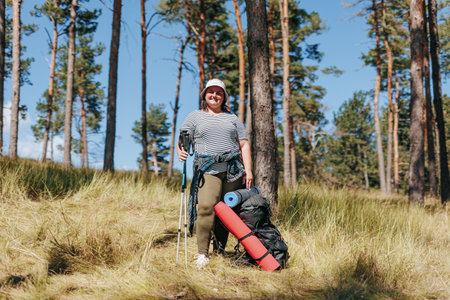 Sculpt Serenity in Natures Canvas as an Overweight Woman Undertakes a Hiking Expedition. Dance with Freedom, Share the Bold Venture of a Plus-Size Female Explorer, and Chronicle Soloの写真素材